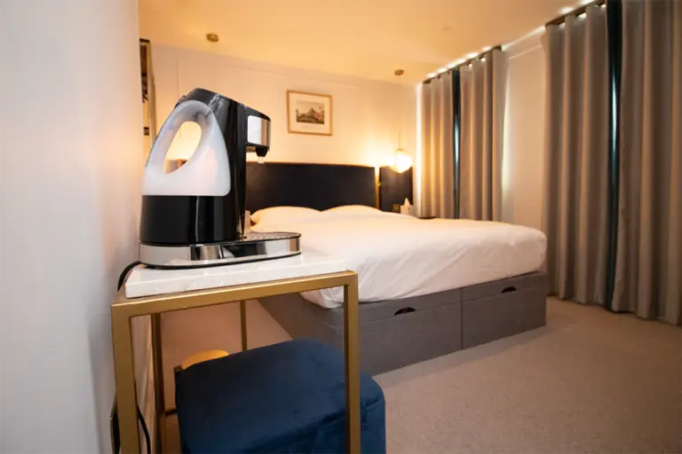 Comfortable bedroom with tea-making setup