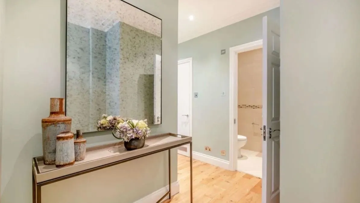 Stylish hallway with a large mirror and rustic decor accents